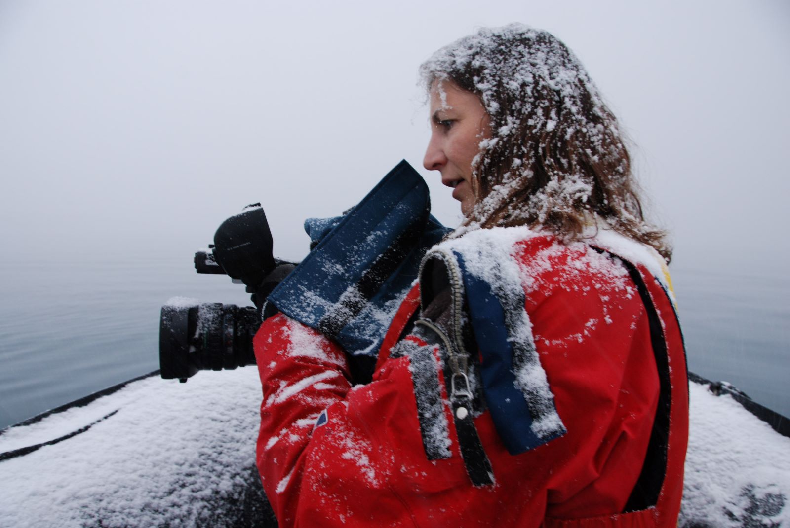 Janet Biggs holds a camera in the snow