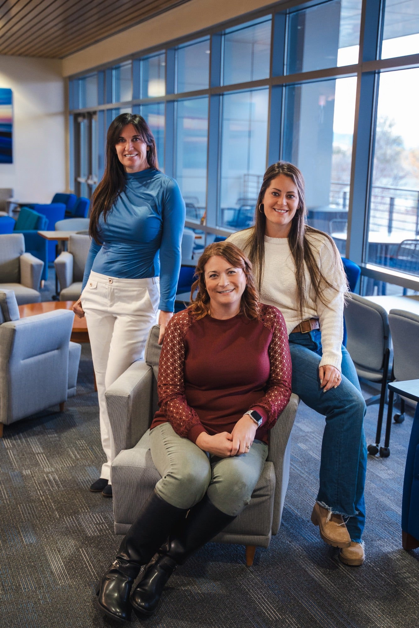 Jill Glenn, Tracee Chapman, and Chelsea Painter pose together in the Norco building.