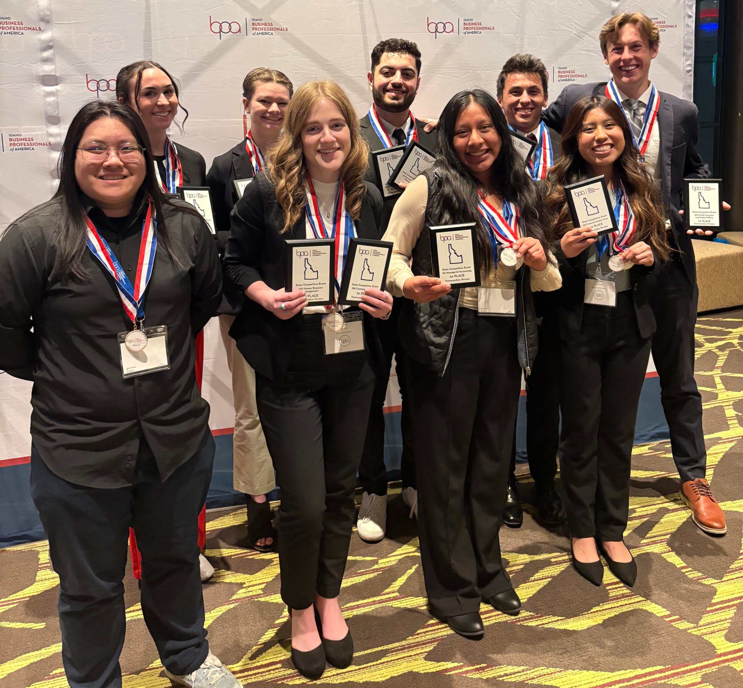 group of students pose with awards