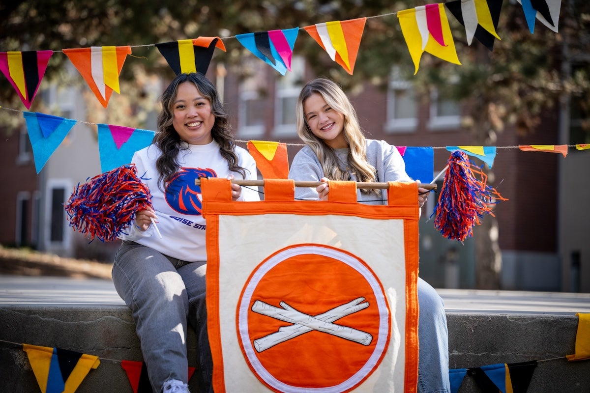 Two students hold a Treefort banner 