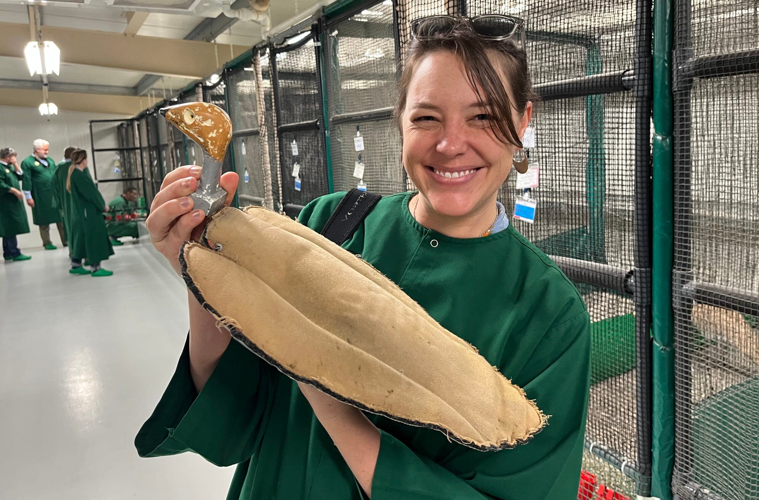 Woman poses with a bird puppet. 
