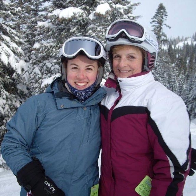 Meg and Arlene Hull wearing Ski gear in front of a snowy tree. 