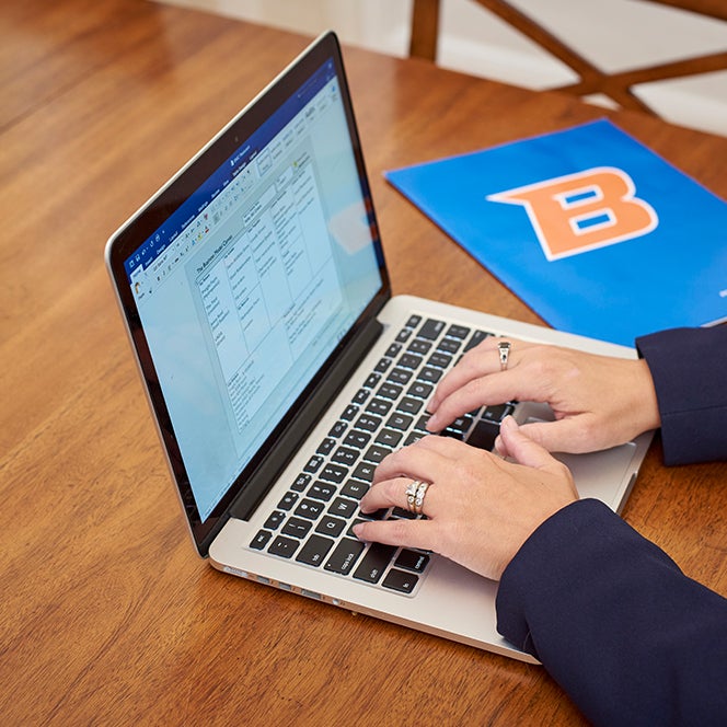 Woman working on laptop.