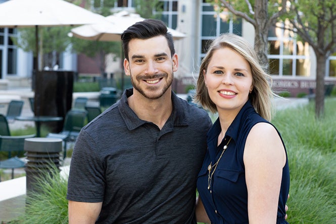 Mike and Olga Bogdanoff standing outside next to each other, while smiling at the camera.