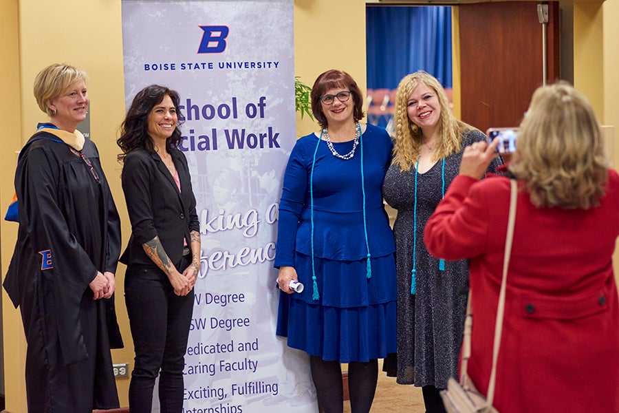 Boise State Online Master of Social Work graduates pose for a photo at a graduation ceremony.