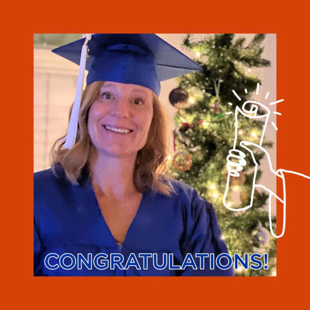 Phoenix Maglaughlin poses in her cap and gown in front of a Christmas tree.