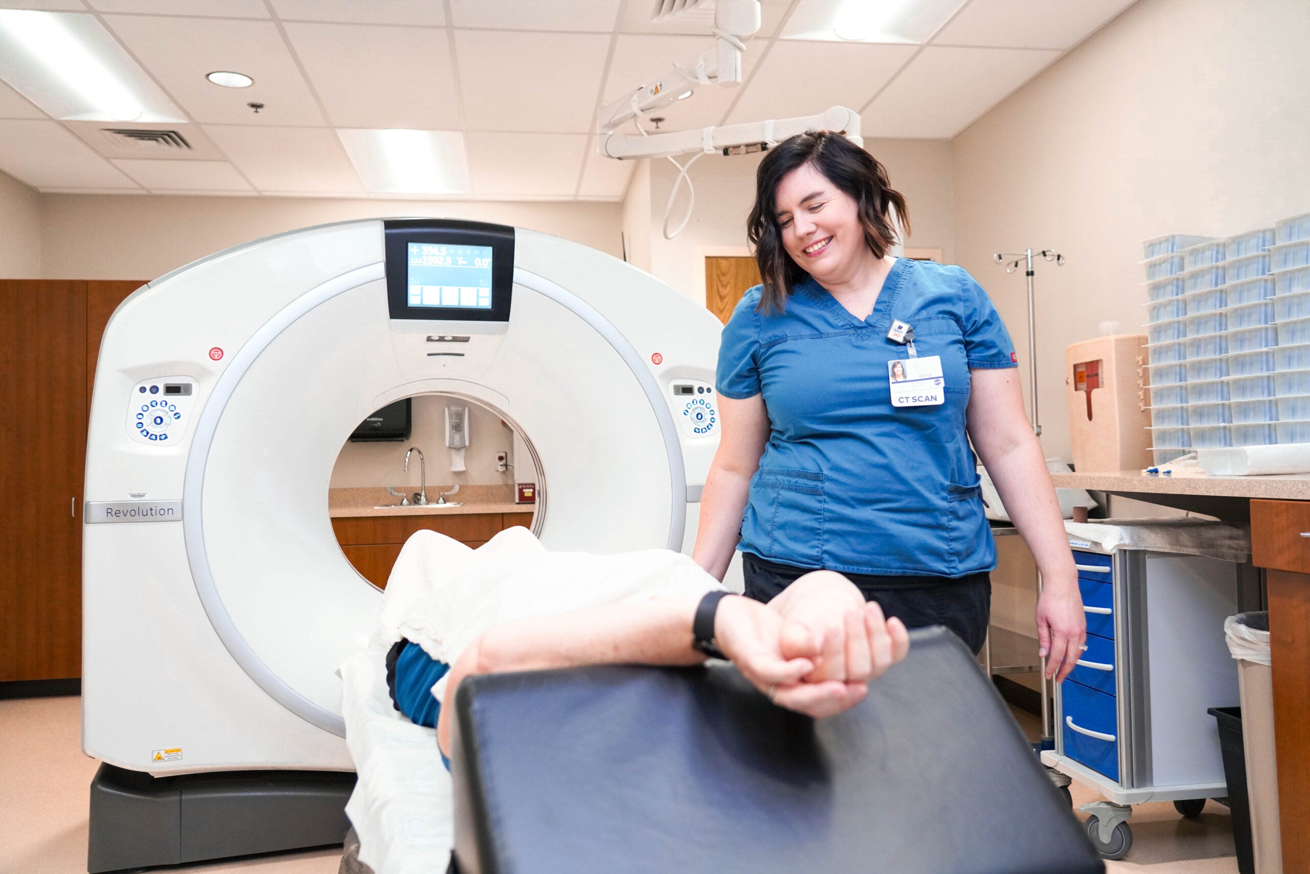 Anna Schreiber helps a patient in an imaging lab.