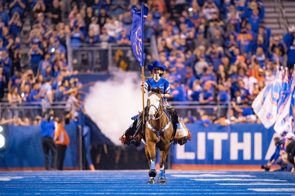 Public health graduate Cathy Jo Ayotte riding her horse at the Boise State football game vs. Fresno State
