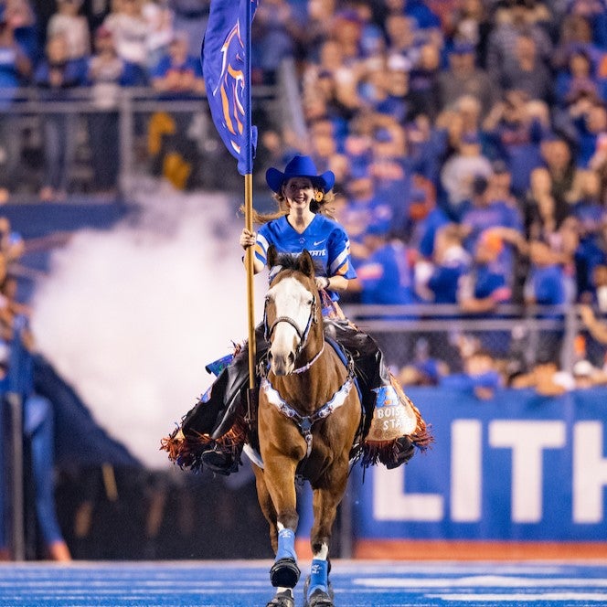 Public health graduate Cathy Jo Ayotte riding her horse at the Boise State football game vs. Fresno State