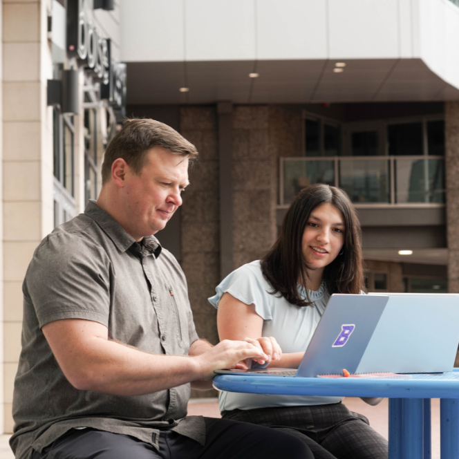 Two university students studying together at a table