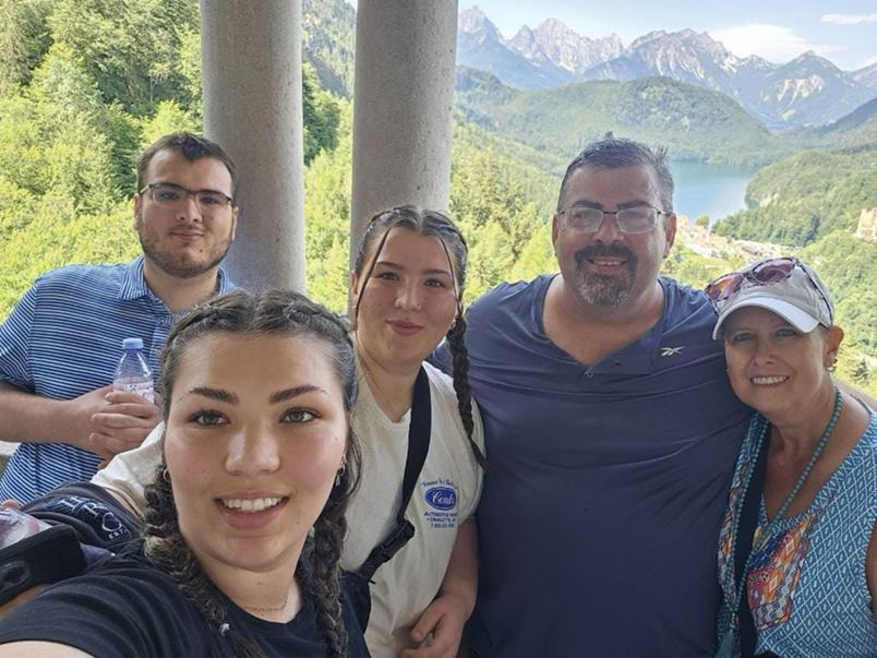 Chochrek and his family in front of a scenic landscape