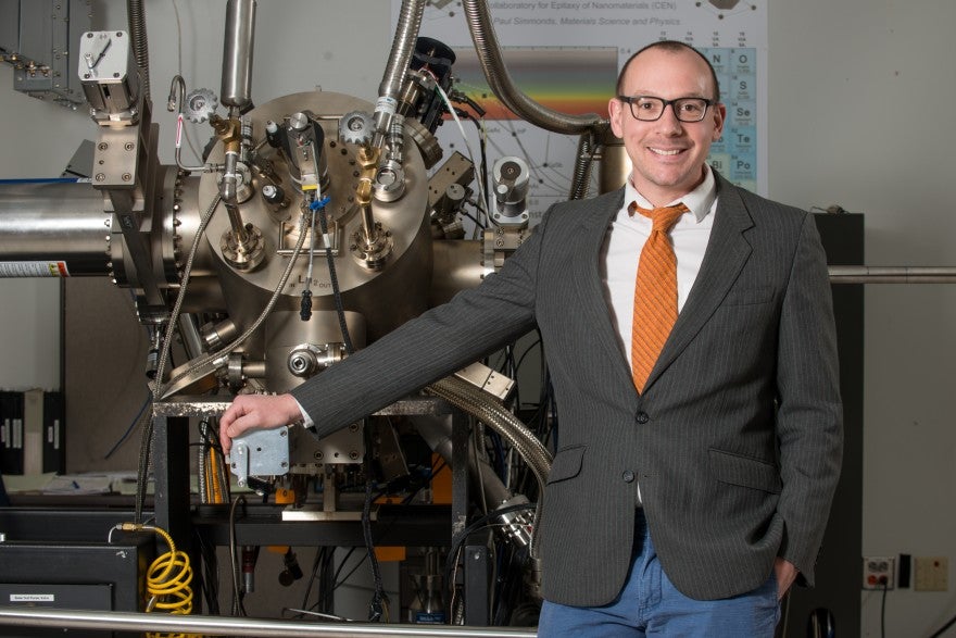 Paul Simmonds standing next to research equipment