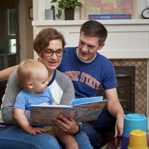 Parents reading to their young child