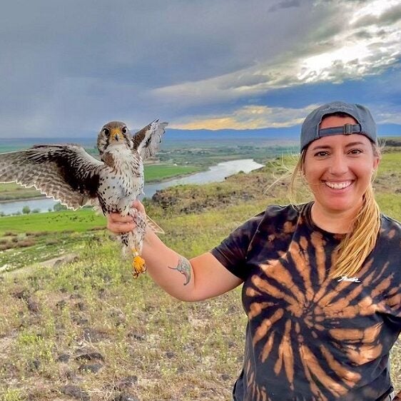 Eden Ravecca holding a prairie falcon