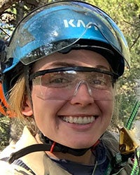 Raptor Biology student Jessy Wilson in climbing gear in a tree