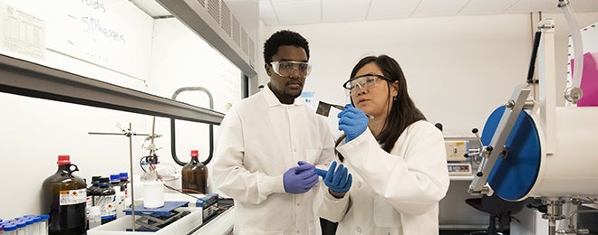 Claire Xiong with assistant in the Materials Science Lab.