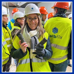 Cassie Koerner smiles while holding basalt and mineralized CO2 at CarbFix, Iceland