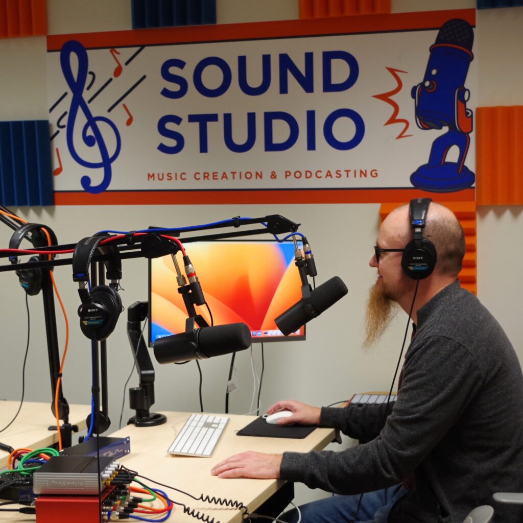 A photo of Chris Saunders in the recording studio at Boise State University