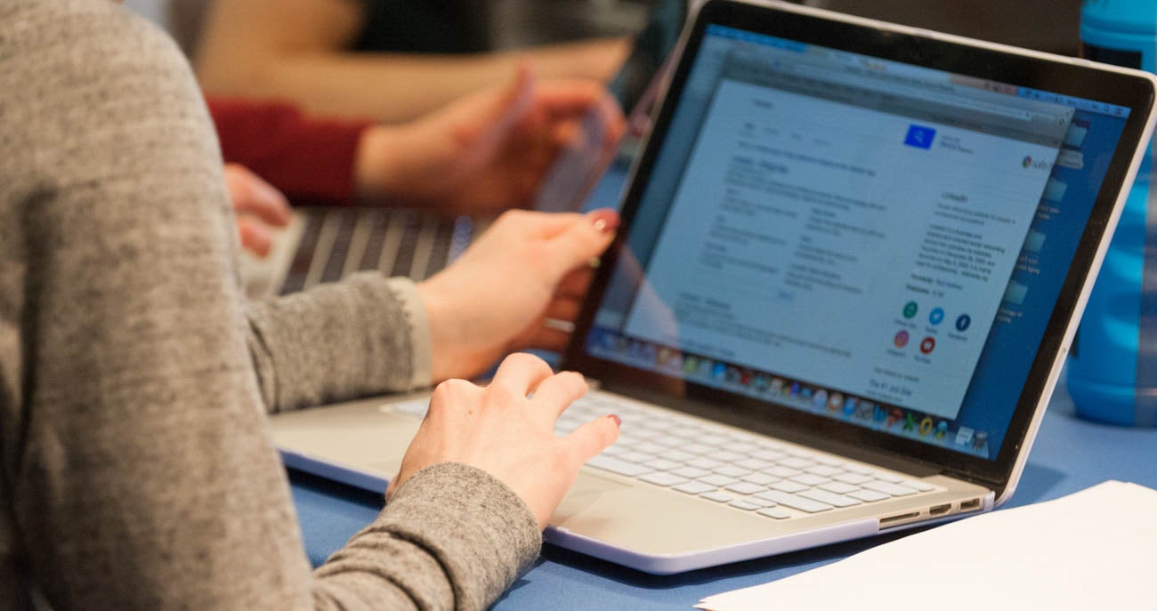 A photograph of an individual using a laptop as they study their coursework at Boise State University.