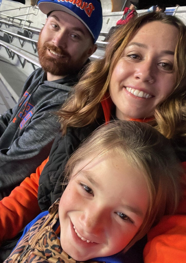 Erin Keen and her family watch the Broncos play football