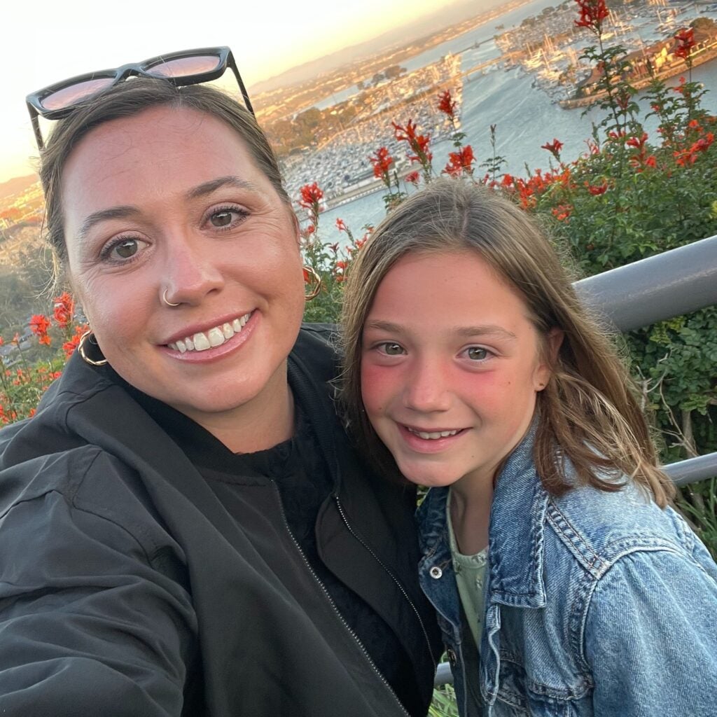 Erin Keen and her daughter Ada stand in front of the Dana Point Marina