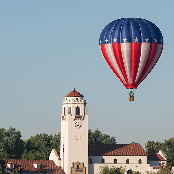 Hot air balloon flying behind Boise depot