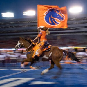 Horse and rider with Boise State flag in albertson stadium