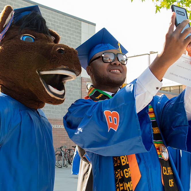 graduate takes selfie with buster bronco