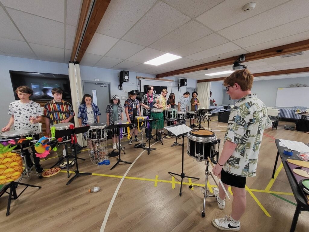 Cameron Repp instructs young drummers at the All Star Drumline Camp using instruments and accessories he bought with funds from an award given in honor of Boise State instructor Peter Magadini.