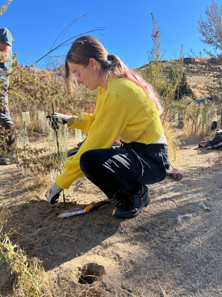 Student digs in the dirt. 