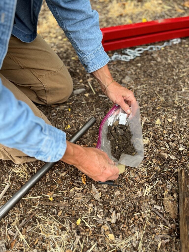 Close up of soil in bag in a farmers field.