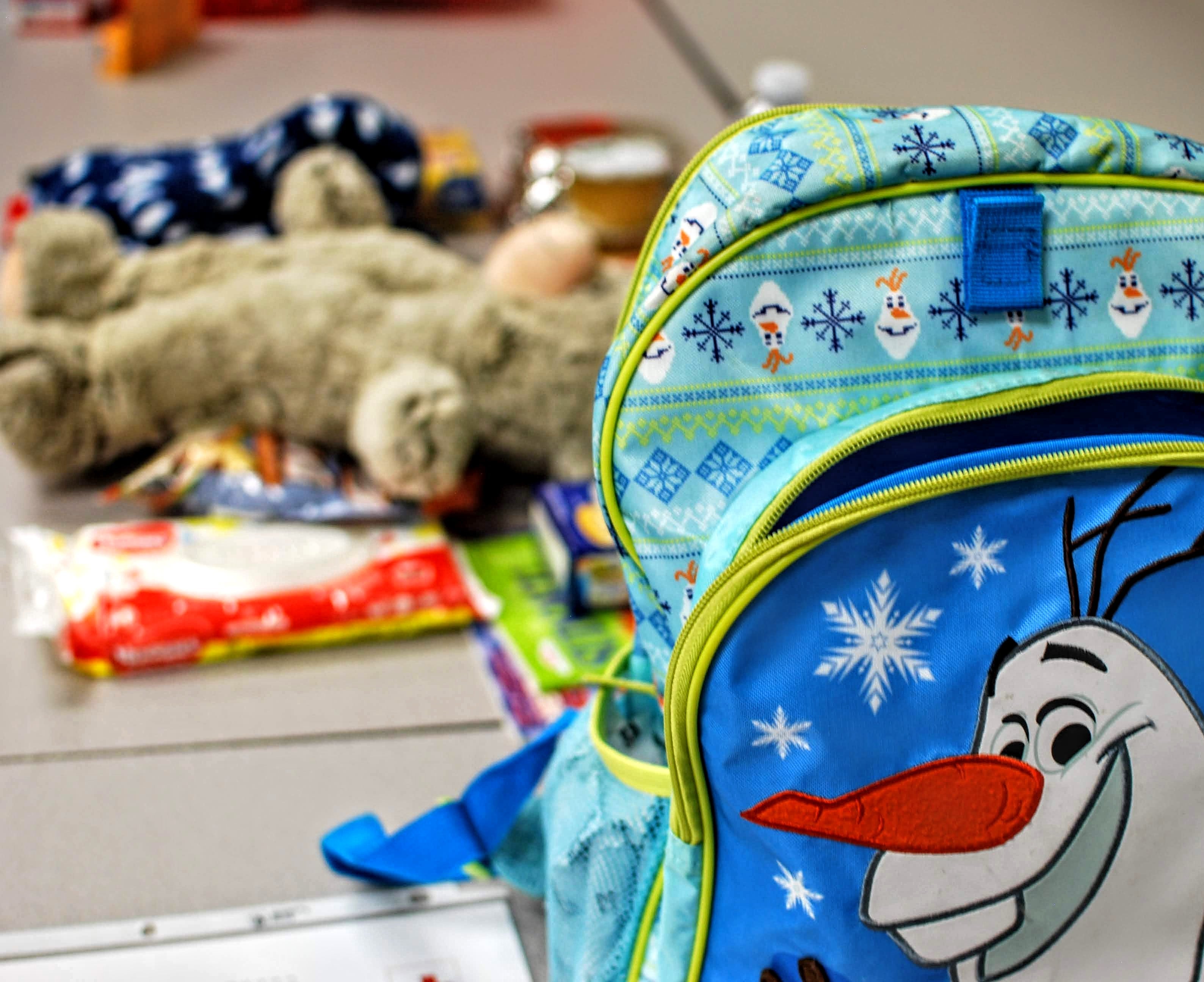 A children's backpack and teddy bear.