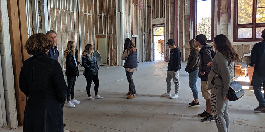 students stand inside a warehouse