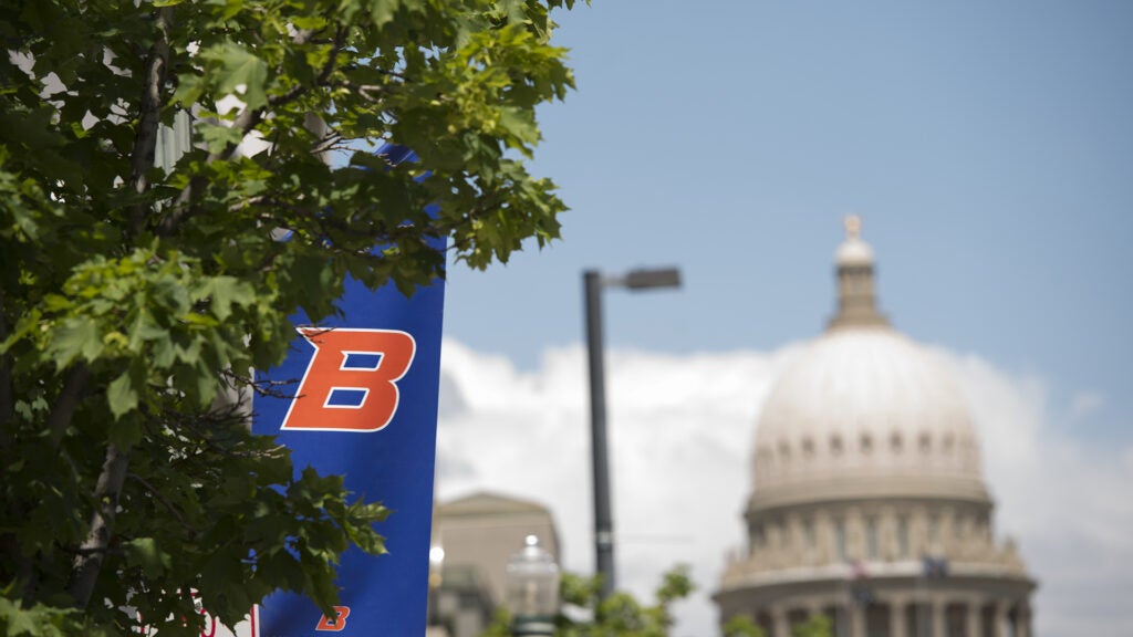 Annual Report header. Photo of Capitol building with Boise State Banner in the foreground.