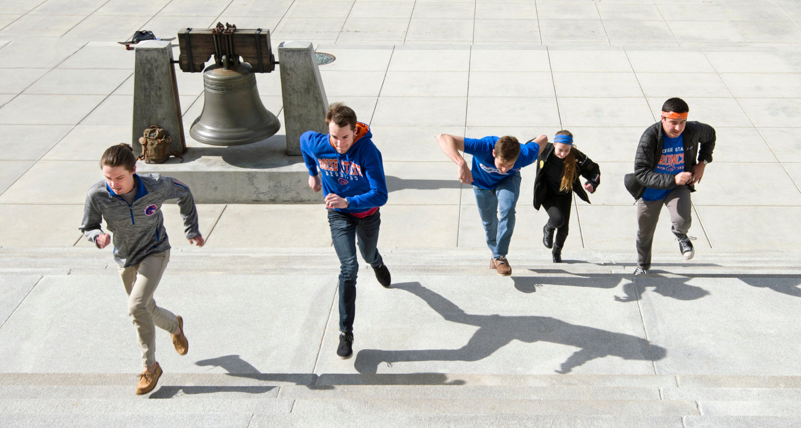 Students running up the steps at the capitol building in Boise