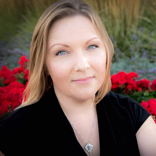 Portrait of Daneva Vance with red flowers in background