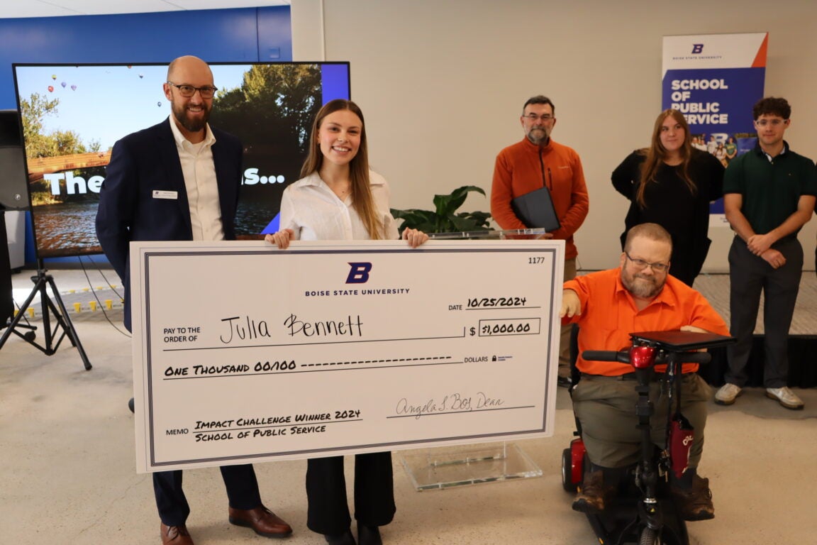 Julia Bennett winning Impact Challenge with Check