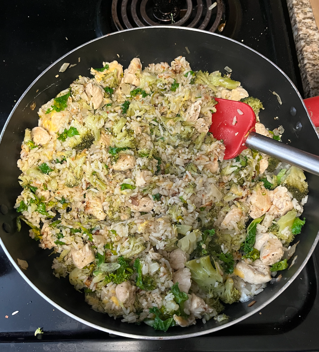 Chicken, rice, and broccoli in a pan