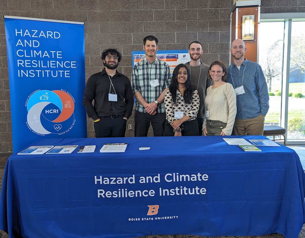 A group of persons present a table top display