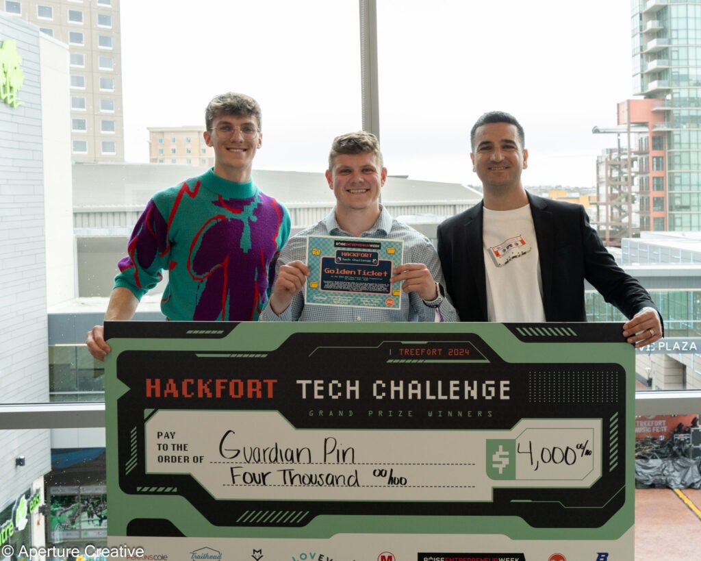 Hackfort Tech Challenge Winne Jake Stubber with Check and Boise Entrepreneur Week Golden Ticket pictured with Trailhead Staff