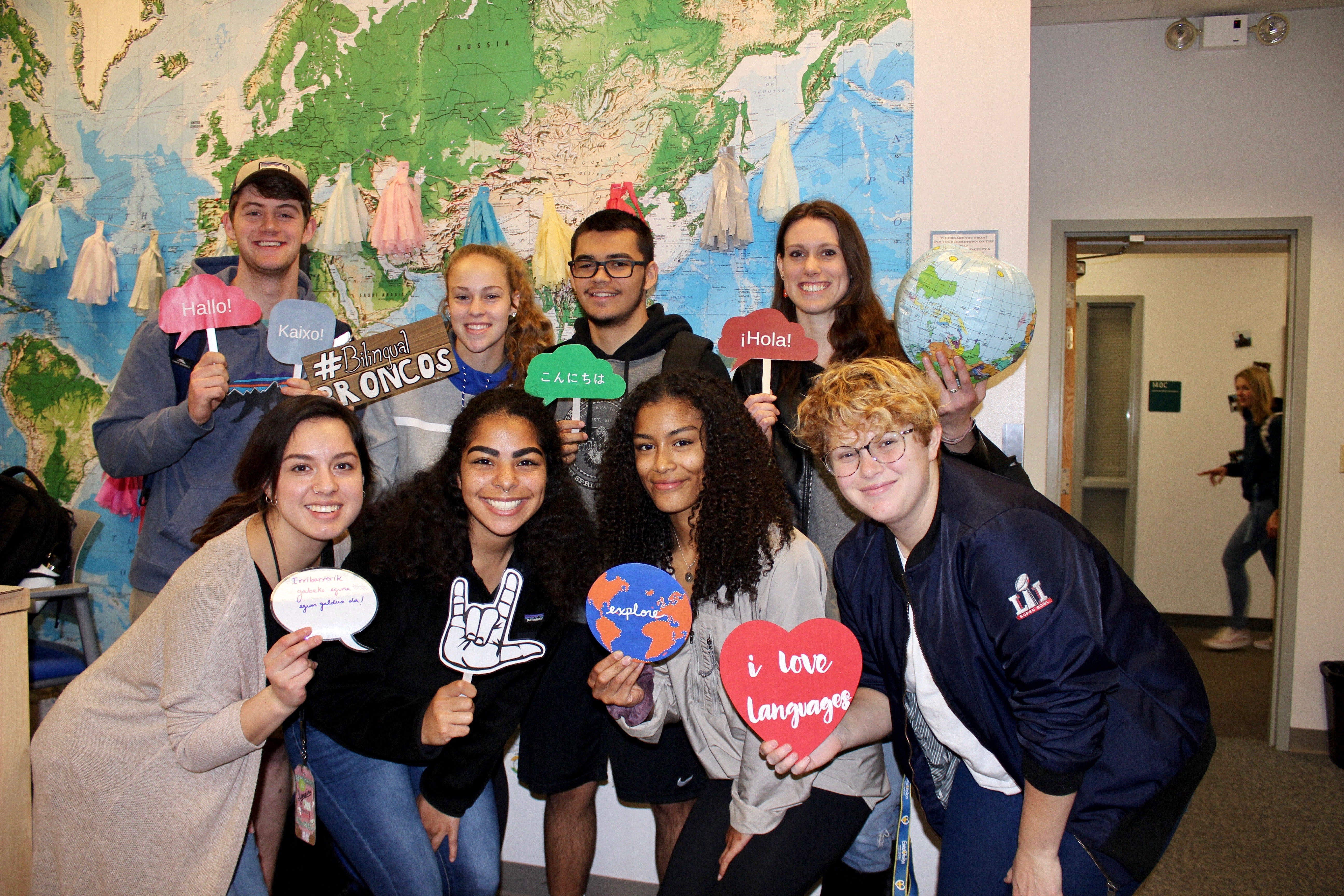 Photo of students in WLRC in front of map with photo booth props